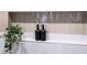 Shower niche with stacked tile, decorative plant, and refillable shampoo and conditioner bottles at 1788 Piper Se Cir, Atlanta, GA 30316