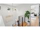Modern staircase with black metal railings and natural wood steps, complemented by stylish lighting and a potted plant at 1788 Piper Se Cir, Atlanta, GA 30316