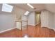 A bonus room features wood floors, stairway, and two skylights for natural light at 1849 Linnet Ne Ct, Roswell, GA 30075