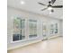 Spacious living room with light hardwood floors, large windows, and ceiling fan at 5619 Tillman Way, Powder Springs, GA 30127