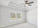 Light-filled main bedroom with tray ceilings, ceiling fan, and neutral carpet at 5619 Tillman Way, Powder Springs, GA 30127
