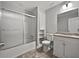 A bathroom with a tub-shower combo, toilet, and a vanity with storage offers functionality and a clean aesthetic at 99 Cedars Glen Way, Villa Rica, GA 30180