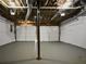 A large garage offers ample storage, with two doors, a central support beam, and exposed ceiling infrastructure at 99 Cedars Glen Way, Villa Rica, GA 30180