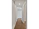 Hallway featuring hardwood floors and white doors at 99 Cedars Glen Way, Villa Rica, GA 30180