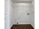 Neat laundry room with shelving and hardwood floors at 99 Cedars Glen Way, Villa Rica, GA 30180