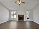 Bright living room featuring a stone fireplace and neutral decor at 99 Cedars Glen Way, Villa Rica, GA 30180