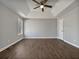 Spacious main bedroom featuring hardwood floors, ceiling fan and large window at 99 Cedars Glen Way, Villa Rica, GA 30180