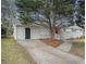 Charming single-story home with painted white brick and well-maintained front yard and driveway at 1146 Canal St, Decatur, GA 30032