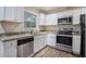 Modern kitchen with granite countertops, stainless steel appliances, and white cabinets at 1146 Canal St, Decatur, GA 30032