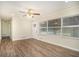 Sun-filled living room featuring a modern ceiling fan, laminate flooring, and large window at 1146 Canal St, Decatur, GA 30032