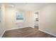 Well-lit room with laminate floors and a view into the kitchen, complemented by a bright window at 1146 Canal St, Decatur, GA 30032