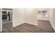 Open-concept area with laminate flooring, connecting the kitchen and living spaces, and a large window at 1146 Canal St, Decatur, GA 30032