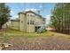 Backyard view of a two story house with a deck and stairs to the yard at 1412 Great Shoals Dr, Lawrenceville, GA 30045