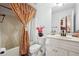 Bathroom with a vanity, toilet, bathtub, and patterned curtains for the shower at 1412 Great Shoals Dr, Lawrenceville, GA 30045