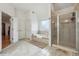 Bright bathroom with tiled floors, soaking tub, and glass enclosed shower with tile surround at 1412 Great Shoals Dr, Lawrenceville, GA 30045