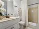 Well-lit bathroom featuring a vanity with a sink and a shower/tub combination with a white shower curtain at 1412 Great Shoals Dr, Lawrenceville, GA 30045