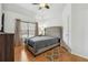 Bright bedroom with hardwood floors, ceiling fan and neutral paint scheme at 1412 Great Shoals Dr, Lawrenceville, GA 30045