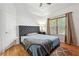 Bedroom with hardwood floors, a gray headboard bed, and a large window with natural light at 1412 Great Shoals Dr, Lawrenceville, GA 30045