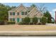 Charming two-story brick home featuring manicured landscaping and traditional architectural details at 1412 Great Shoals Dr, Lawrenceville, GA 30045