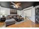 Cozy living room with dark ceiling, hardwood floors, a large sectional couch, and stylish decor at 1412 Great Shoals Dr, Lawrenceville, GA 30045