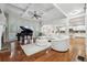 Spacious living room featuring coffered ceilings, piano, hardwood flooring, and abundant natural light at 1412 Great Shoals Dr, Lawrenceville, GA 30045