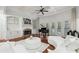 Bright living room boasts fireplace, built-in shelving, hardwood floors, and a grand piano at 1412 Great Shoals Dr, Lawrenceville, GA 30045
