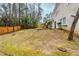 Expansive backyard with mossy grass, a wooden fence, and mature trees, creating a serene outdoor space at 2202 Troutdale Dr, Decatur, GA 30032