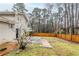 Spacious backyard with a wooden fence offering privacy and a partially covered patio at 2202 Troutdale Dr, Decatur, GA 30032