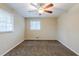 Bedroom with ceiling fan, carpet floors, and natural light from two windows at 2202 Troutdale Dr, Decatur, GA 30032