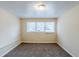 Cozy bedroom with carpet flooring and a large window providing natural light at 2202 Troutdale Dr, Decatur, GA 30032