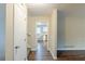 Hallway with wood floors leading to a kitchen featuring white cabinets at 2202 Troutdale Dr, Decatur, GA 30032