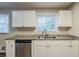 Bright kitchen featuring granite countertops, stainless steel appliances, and white cabinetry at 2202 Troutdale Dr, Decatur, GA 30032