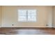 Living room featuring wood floors, neutral walls, and a window with blinds at 2202 Troutdale Dr, Decatur, GA 30032