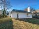 View of the backyard featuring the home's exterior, well-maintained lawn, and partial fencing at 3782 Westchase Dr, Marietta, GA 30066
