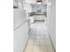 Galley kitchen features white cabinets, appliances, and white tile floors at 3782 Westchase Dr, Marietta, GA 30066
