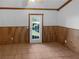 Cozy living area features tile flooring, wood-paneled walls, and a glass panel back door at 3782 Westchase Dr, Marietta, GA 30066