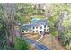 Aerial view of an elegant two-story home with well-manicured lawn and mature trees at 805 Wesley Oak Rd, Atlanta, GA 30328