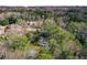 Aerial view of the home with a lush, wooded lot surrounding the property with mature trees and a private pool at 805 Wesley Oak Rd, Atlanta, GA 30328