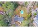 Stunning aerial view of a home with a beautiful backyard and a sparkling inground pool nestled among mature trees at 805 Wesley Oak Rd, Atlanta, GA 30328