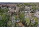 An aerial view of a beautiful home surrounded by lush greenery with a sparkling pool, offering serene privacy at 805 Wesley Oak Rd, Atlanta, GA 30328
