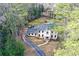 An aerial view of an elegant home with in-ground pool surrounded by mature trees at 805 Wesley Oak Rd, Atlanta, GA 30328