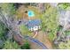 Aerial view of a stately home with a pool, nestled amongst mature trees and greenery at 805 Wesley Oak Rd, Atlanta, GA 30328