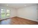 Spacious basement featuring wood flooring, recessed lighting, and double doors at 805 Wesley Oak Rd, Atlanta, GA 30328