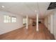 Open basement area with pillars, recessed lighting, wood flooring, and fireplace at 805 Wesley Oak Rd, Atlanta, GA 30328