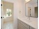 Bright bathroom with gray vanity, quartz countertop, and black hardware, with view into adjacent room at 805 Wesley Oak Rd, Atlanta, GA 30328