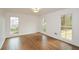 Bright bedroom with hardwood floors, three windows, and neutral paint at 805 Wesley Oak Rd, Atlanta, GA 30328