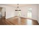 Sun-filled dining area featuring paneled walls, hardwood flooring, and large windows offering scenic views at 805 Wesley Oak Rd, Atlanta, GA 30328