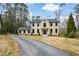 Elegant front exterior view of a two-story home with a well-manicured lawn and a long driveway at 805 Wesley Oak Rd, Atlanta, GA 30328