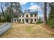 A stately two-story home with manicured front lawn and elegant entrance at 805 Wesley Oak Rd, Atlanta, GA 30328