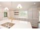 Bright kitchen featuring stone countertops, a large island, and stainless sink at 805 Wesley Oak Rd, Atlanta, GA 30328